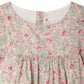 Close-up of Bonpoint's Girls' Lysiane Dress, showcasing English embroidery, a round neckline, and gathered fabric below the chest.