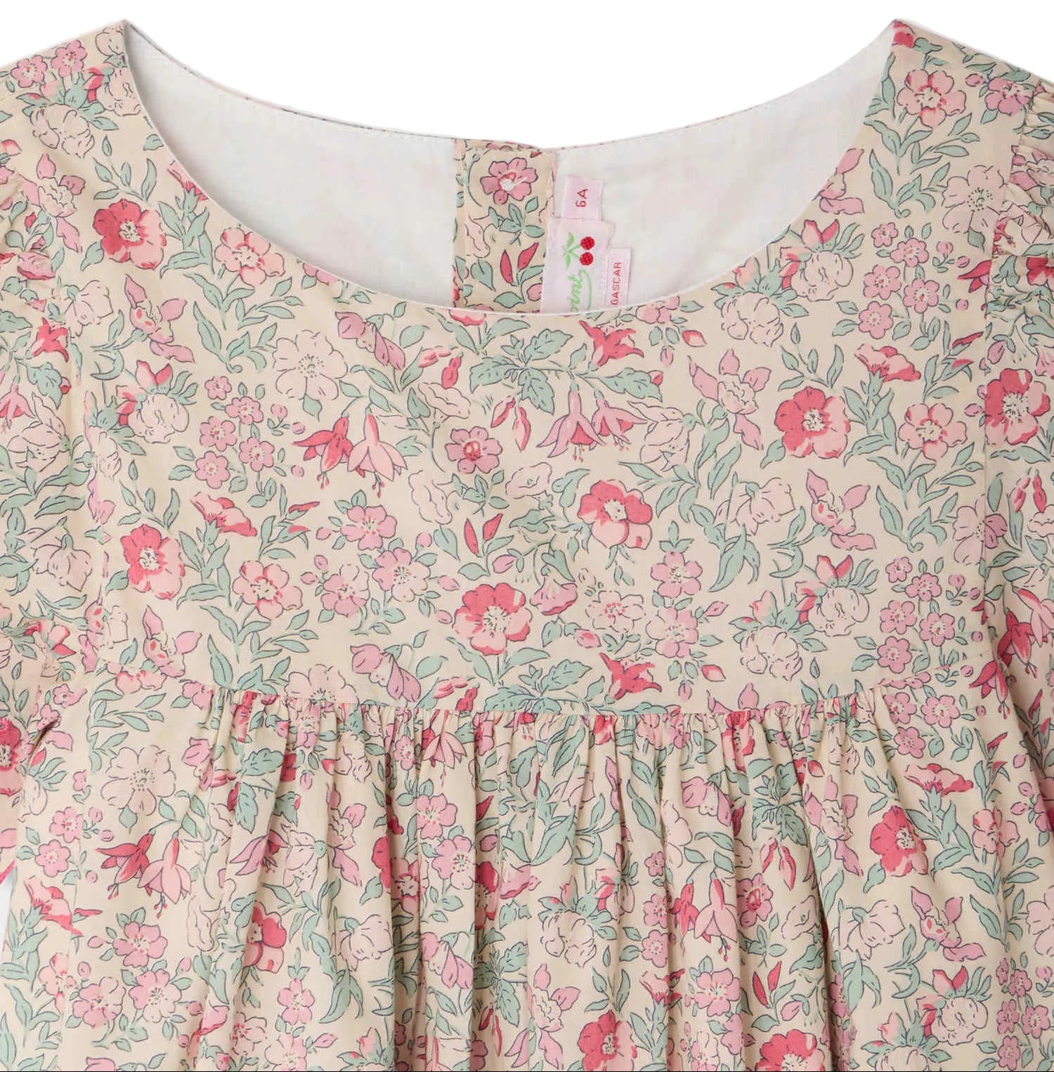 Close-up of Bonpoint's Girls' Lysiane Dress, showcasing English embroidery, a round neckline, and gathered fabric below the chest.