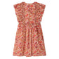 The Girls' Lizzy Dress with Ruffles in Liberty Fabric by Bonpoint is a sleeveless, knee-length dress featuring ruffled shoulders and a red, pink, and beige floral print, crafted from organic cotton.