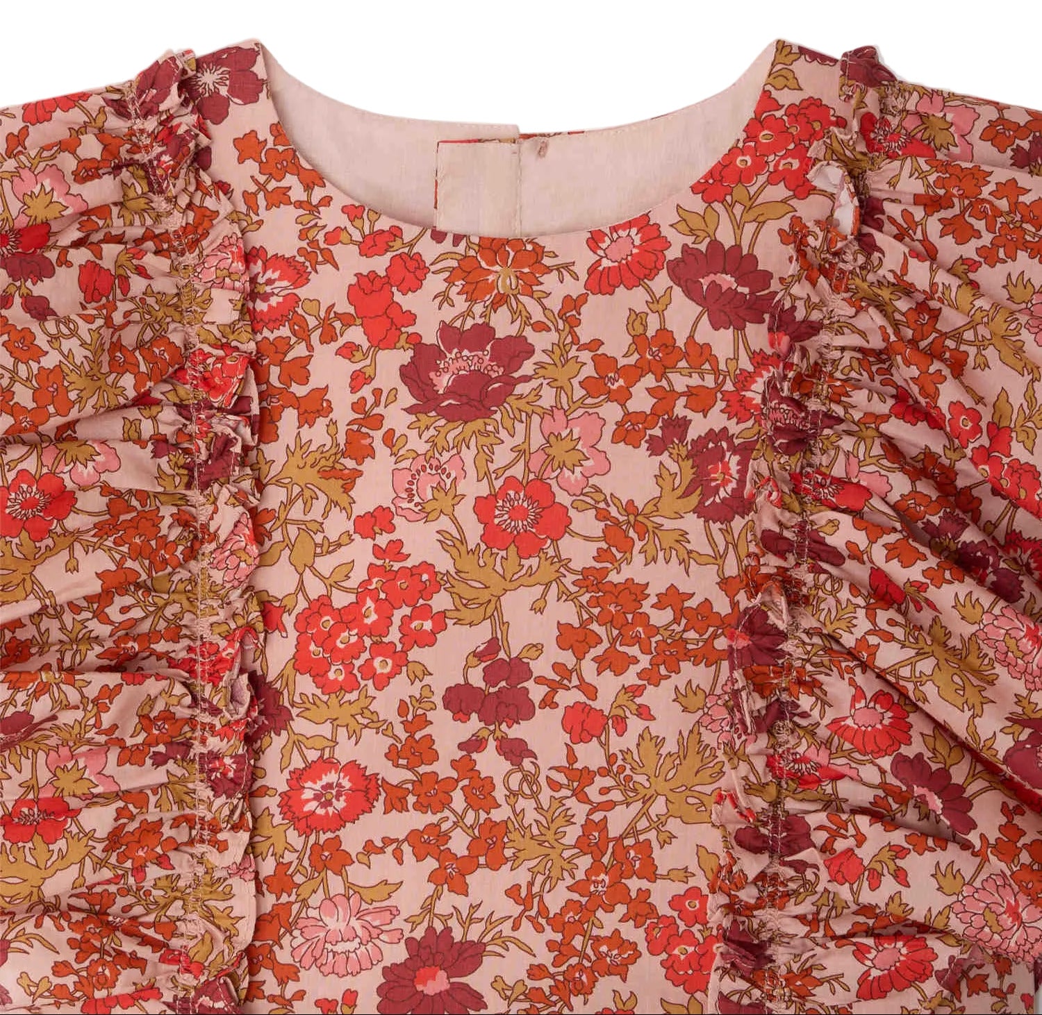 Close-up of the Girls' Lizzy Dress with Ruffles in Liberty Fabric by Bonpoint, featuring a pink base with a bold red, orange, and yellow floral print and vertical ruffle details on each side.