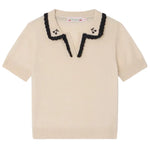 The Bonpoint Girls' Lisette Sweater features short sleeves, a cream knit, a scalloped black-trimmed notched lapel collar, and delicate hand-embroidered cherries near the neckline.