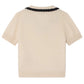The Bonpoint Girls' Lisette Sweater features a hand-embroidered notched lapel collar and black scalloped trim, shown flat with the back facing up.