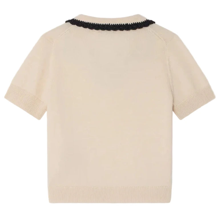 The Bonpoint Girls' Lisette Sweater features a hand-embroidered notched lapel collar and black scalloped trim, shown flat with the back facing up.