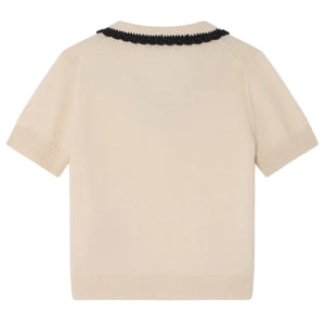 The Bonpoint Girls' Lisette Sweater features a hand-embroidered notched lapel collar and black scalloped trim, shown flat with the back facing up.