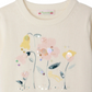 The Bonpoint Girls' Elvira Jacquard Sweater features cream knit with pink and yellow intarsia flowers, green leaves, and hand-embroidered sequins embellishing the front.