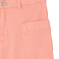 Close-up of the waist and pocket on Bonpoint Girls' Looping Wide-Leg Trousers in light pink organic cotton, with a metal button, belt loop, and stitched pocket detailing.