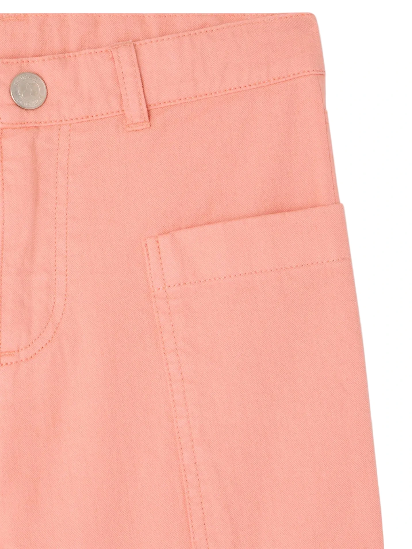Close-up of the waist and pocket on Bonpoint Girls' Looping Wide-Leg Trousers in light pink organic cotton, with a metal button, belt loop, and stitched pocket detailing.
