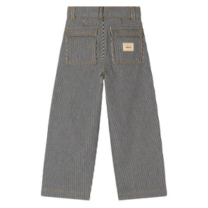 Back view of Bonpoint Girls Jingle Striped Denim Trousers featuring blue and white stripes, wide leg silhouette, two rear pockets, and a patch label above the right pocket.