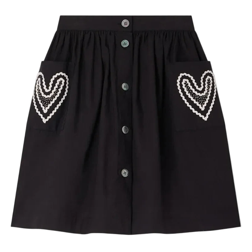 The Bonpoint Girls' Lierre Hand-Embroidered Skirt is black with front buttons and two large front pockets, each adorned with delicate white hand-embroidered hearts.