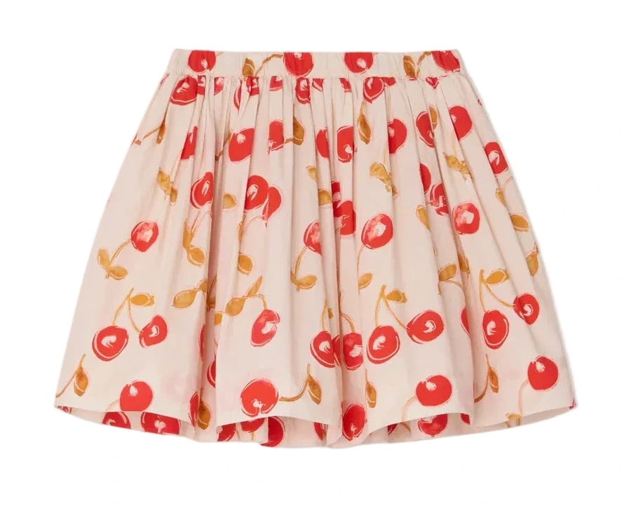 The Girls' Suzon Skirt by Bonpoint is a short, pleated skirt made from organic cotton with a white base, decorated with red cherry prints and yellow-brown stems and leaves.