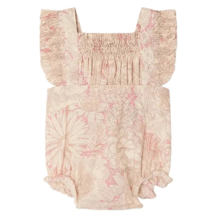 The Bonpoint Baby Girls' Lakiss Romper features Liberty fabric, smocked and hand-embroidered details, ruffled shoulder straps, elastic leg openings, and soft organic cotton for comfort.