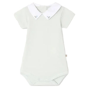 Bonpoint’s Baby Juillet Bodysuit features hand-embroidered sailboats, soft organic cotton, short sleeves, a white Peter Pan collar, and two buttons at the back of the neck.