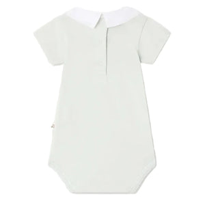 The Bonpoint Baby Juillet Bodysuit features hand-embroidered sailboats, light grey organic cotton, short sleeves, a white collar, buttoned front placket, and stitched edges, shown against a plain white background.