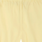 Close-up of Bonpoint’s Baby and Kids' Azur Bloomer in light yellow, featuring a solid color, elastic waistband, and center seam for easy comfort.
