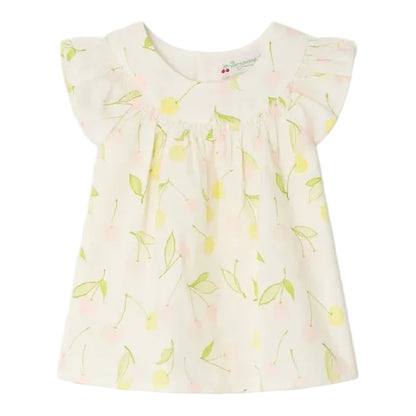 The Bonpoint Baby Girls' and Girls' Lala Blouse is a light-colored cherry print top with short flutter sleeves, featuring yellow and pink cherries with green leaves, crafted from organic cotton and finished with mother-of-pearl buttons.