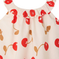 The Bonpoint Baby Girls' and Girls' Niniki Ruffled Dress is an ivory organic cotton dress with a ruffled neckline, adorned with a red cherry and brown stem print.
