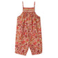 The Bonpoint Baby Girls' Lilisy Dungarees in Liberty fabric are sleeveless, with pink, red, and orange flowers, a hand-embroidered smocked bodice, and elasticized leg openings.