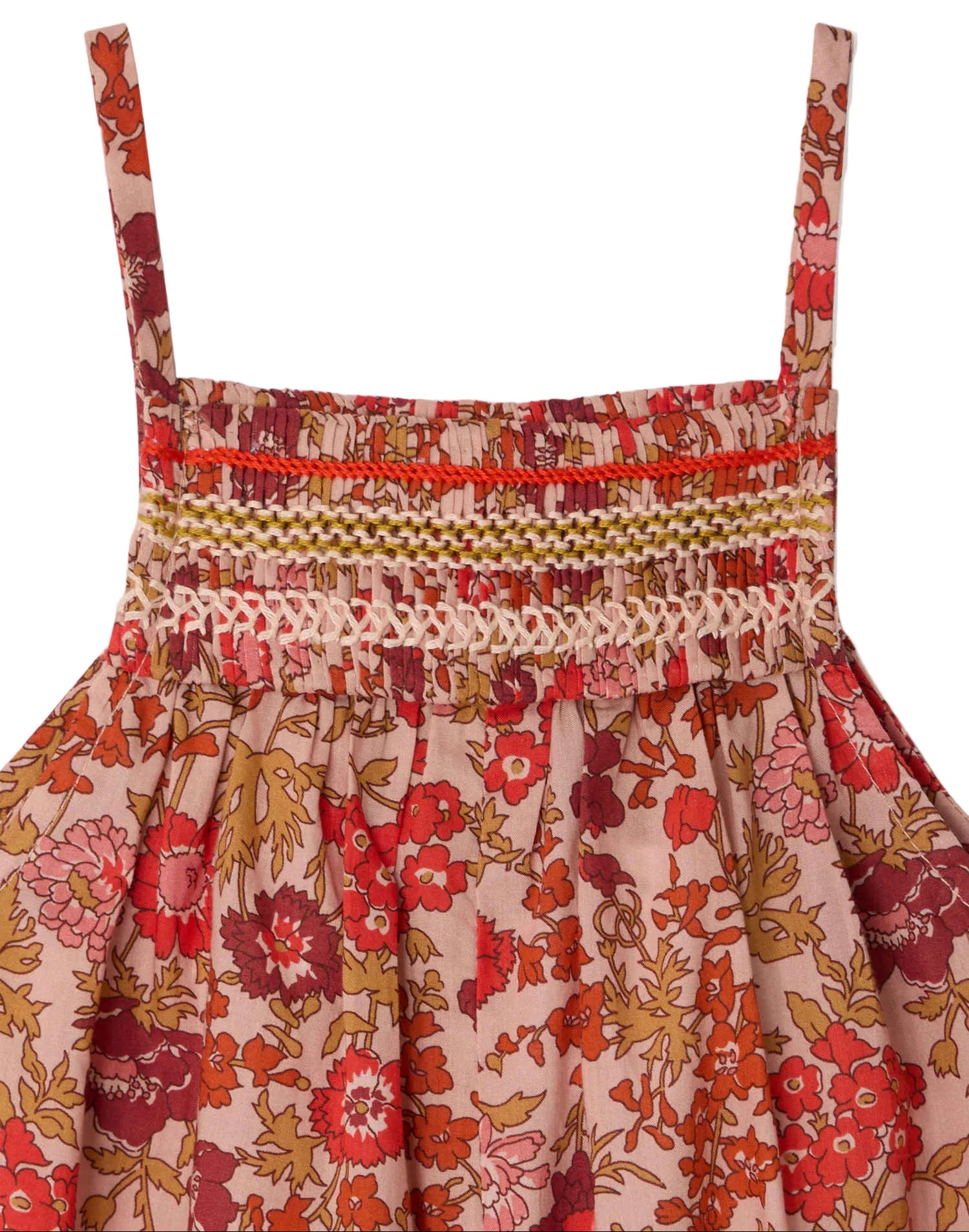 Close-up of Bonpoint's Baby Girls' Lilisy Dungarees in Liberty fabric, featuring thin straps, a floral red, pink, and brown print, and hand-embroidered smocking on the bodice for an artisanal finish.