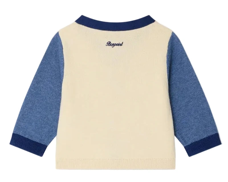 The Bonpoint Baby Boys' Tahiel V-neck Cardigan is cream-colored with blue sleeves and collar, made from organic cotton, and has "Bogesi" embroidered on the back near the neckline.