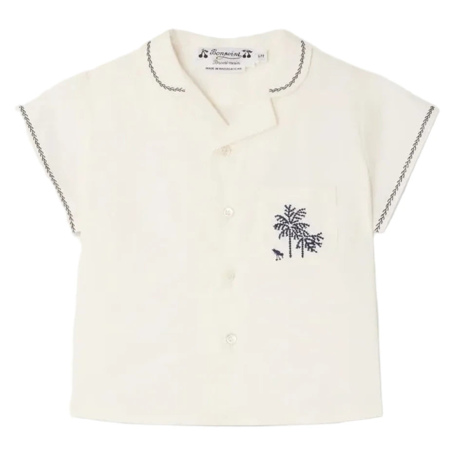 The Bonpoint Baby Boys' and Boys' Lennard Shirt is a short-sleeved cream shirt in organic cotton, with dark stitching on the collar and sleeves, button front, and a chest pocket embroidered with palm trees.