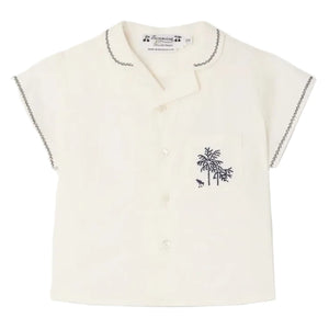 The Bonpoint Baby Boys' and Boys' Lennard Shirt is a short-sleeved cream shirt in organic cotton, with dark stitching on the collar and sleeves, button front, and a chest pocket embroidered with palm trees.