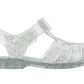 The Igor Clasica Cristal Sandal is a flexible, clear jelly sandal with silver glitter, a closed toe, ankle strap, and flat sole.