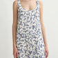 A woman wears the POSSE Rue Shift Dress, a vintage floral sleeveless dress with a blue pattern, standing against a plain light background.