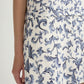 Wearing the POSSE Rue Shift Dress, featuring a blue floral pattern on white, only the lower torso, hip, and part of the arm are visible against a plain background.
