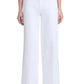 Person wearing Altuzarra's Rudy Pant in high-waisted, wide-leg white with two gold buttons, styled with a navy top and open-toe black heels.