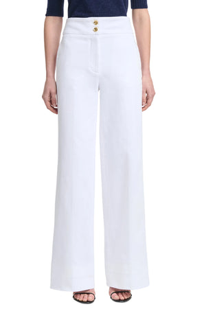Person wearing Altuzarra's Rudy Pant in high-waisted, wide-leg white with two gold buttons, styled with a navy top and open-toe black heels.