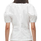 Rear view of a person wearing a 3.1 Phillip Lim Bloom Sleeve Scoop Neck Top with gathered details on the back.