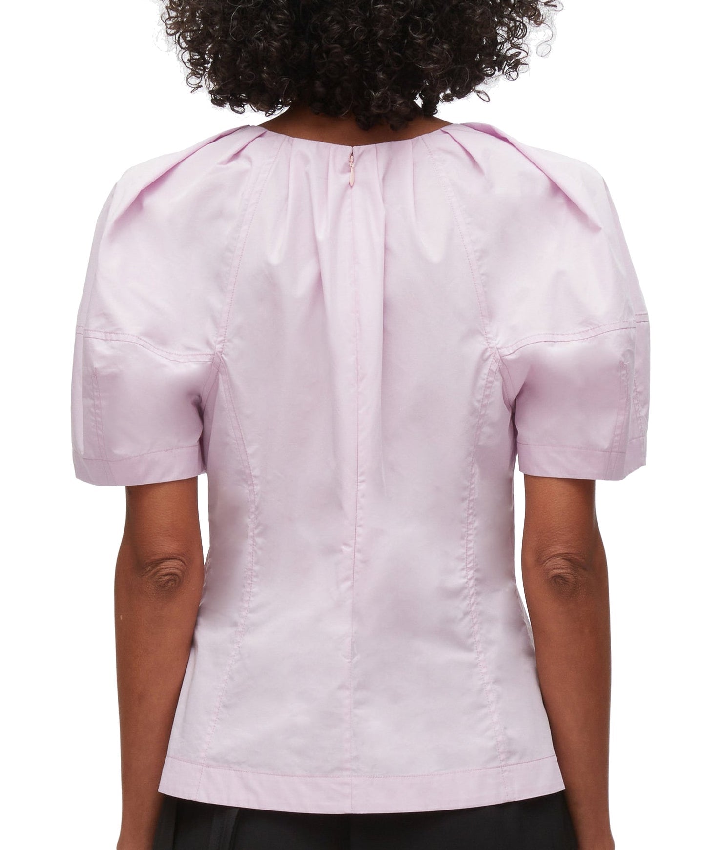 Rear view of a person wearing a pink 3.1 Phillip Lim Bloom Sleeve Scoop Neck Top with short sleeves and a yoke.