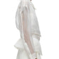 A side profile of a person wearing a sheer white long-sleeve shirt, a white skirt, and an elegant 3.1 Phillip Lim Organza Belted Flounce Jacket by 3.1 Phillip Lim.