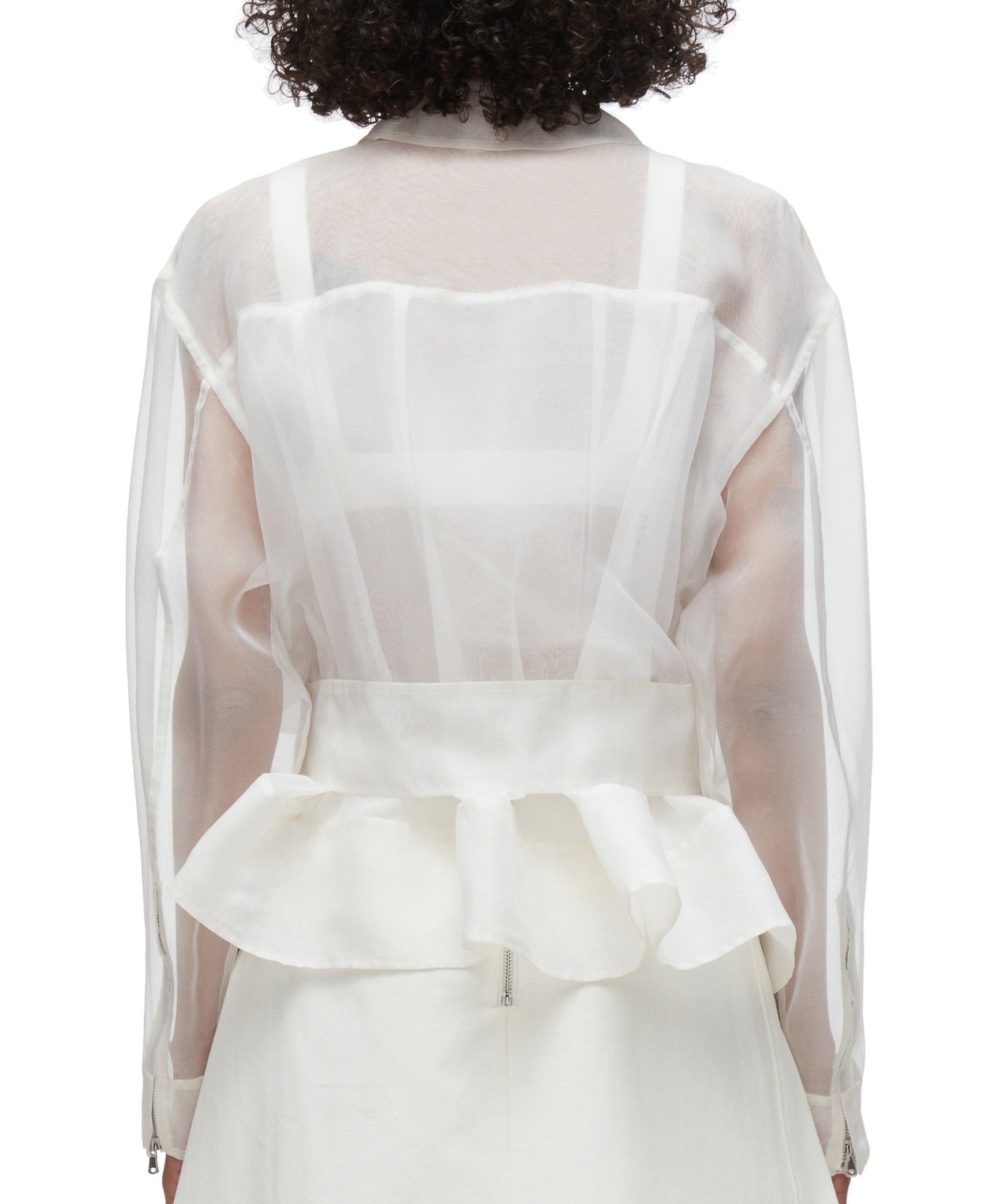 Person wearing a sheer white blouse with long sleeves and a ruffled hem, paired with the 3.1 Phillip Lim Organza Belted Flounce Jacket by 3.1 Phillip Lim, seen from the back.