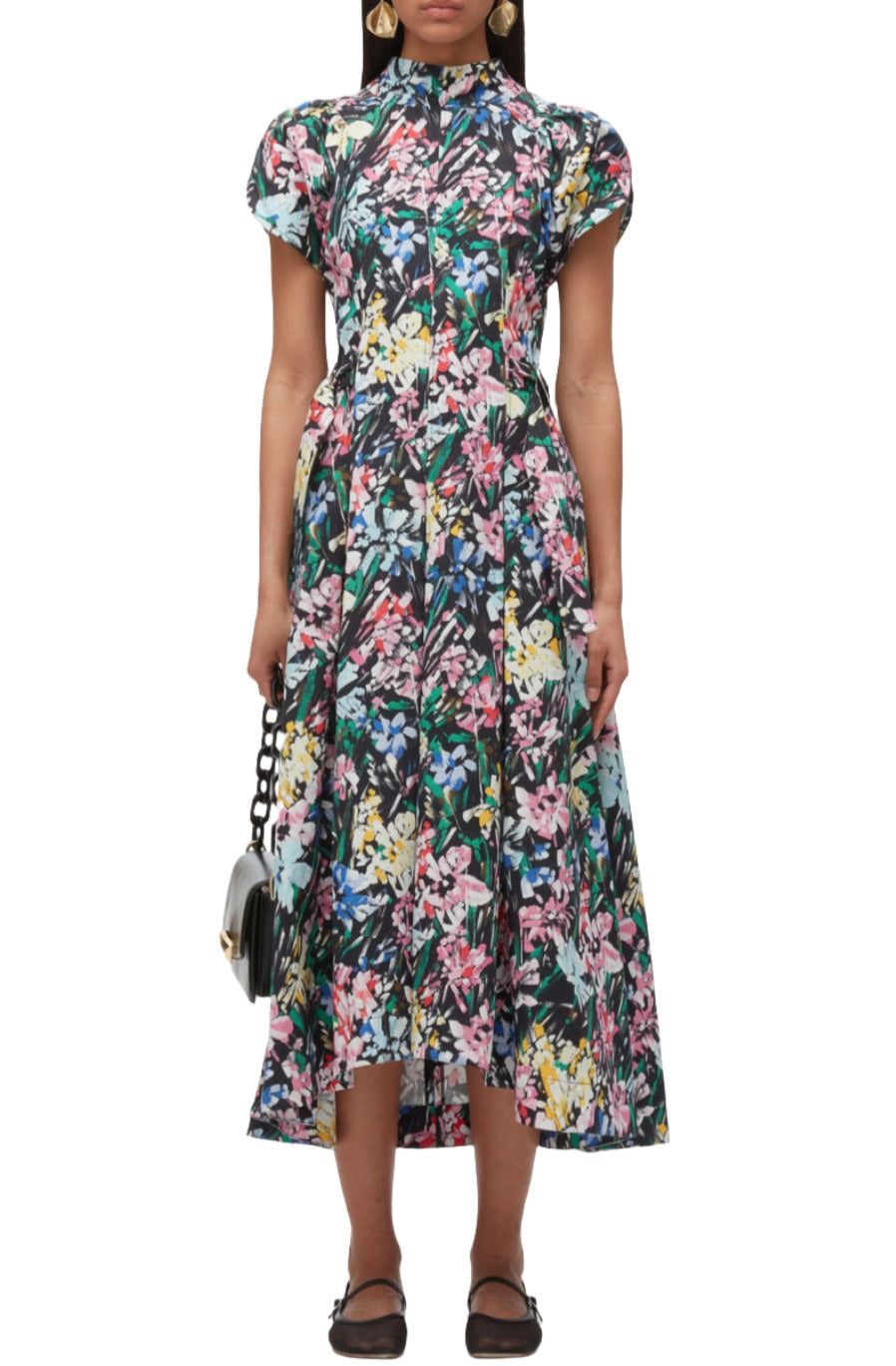 Person wearing a 3.1 Phillip Lim Flowerworks Puff Sleeve Flare Dress and carrying a small black handbag, standing against a plain background.