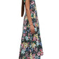 A person wearing a colorful floral-patterned A-line dress stands sideways, displaying the dress's length and short sleeves. The 3.1 Phillip Lim Flowerworks Puff Sleeve Flare Dress by 3.1 Phillip Lim is paired with black flat shoes, completing the look.