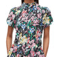 A person wearing a 3.1 Phillip Lim Flowerworks Puff Sleeve Flare Dress with statement earrings, standing with hands in pockets.