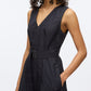 A woman models the 3.1 Phillip Lim Crisscross Back Midi Dress, featuring a sleeveless V-neck, belted waist, A-line skirt in technical poplin, and side pocket, shown from shoulders to above the knee.