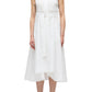 A person wearing the 3.1 Phillip Lim Crisscross Back Midi Dress, a sleeveless white V-neck dress with a belted waist and crisscross back, pairs it with black sandals while standing against a plain white background.