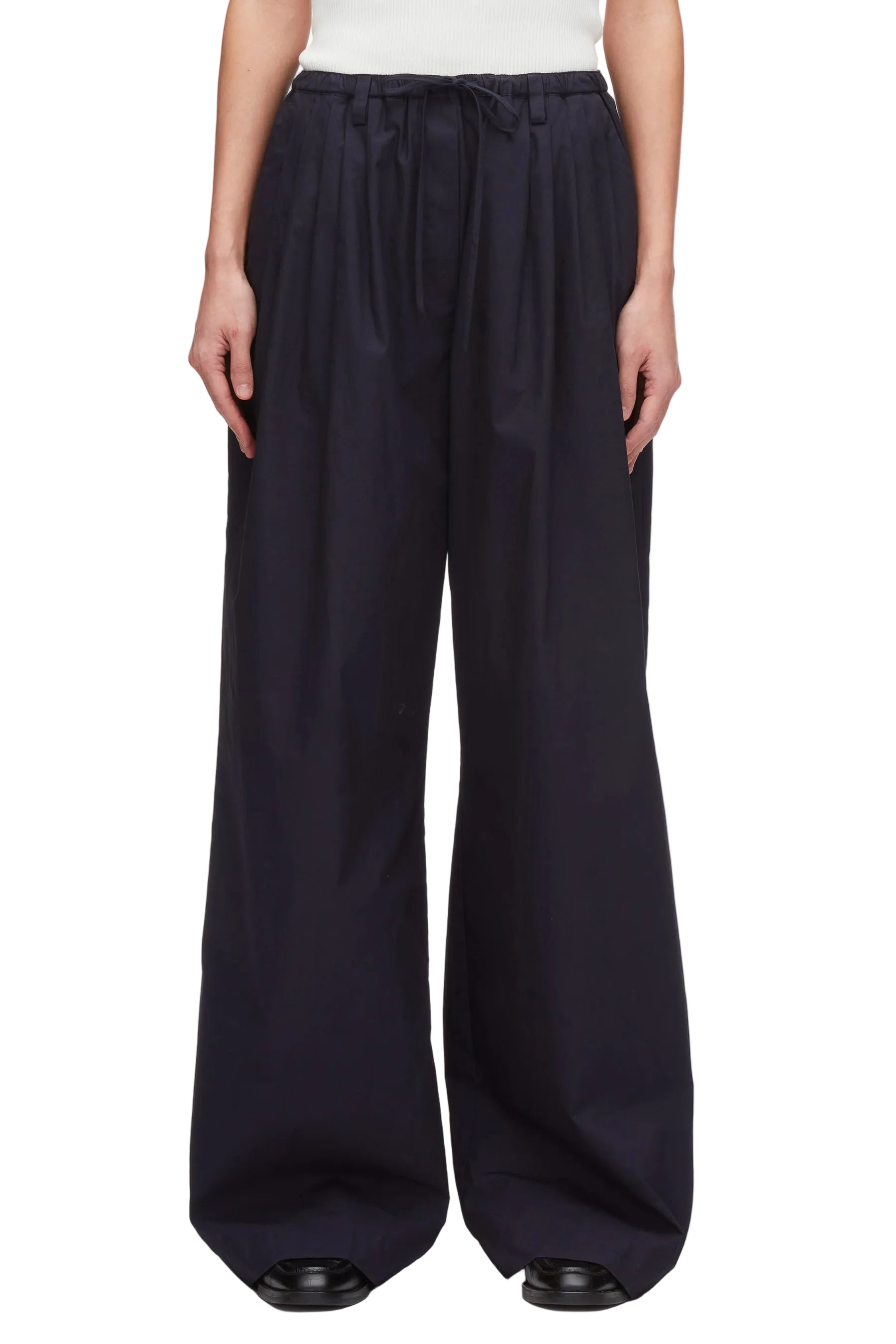 A person wears 3.1 Phillip Lim Structured Cotton Pull-On Straight Leg Pants with a white top and black shoes.