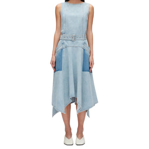 A person wearing the 3.1 Phillip Lim Ghost Patch Midi Denim Dress, featuring a matching adjustable belt, two front pockets, and a handkerchief hem, paired with white shoes.