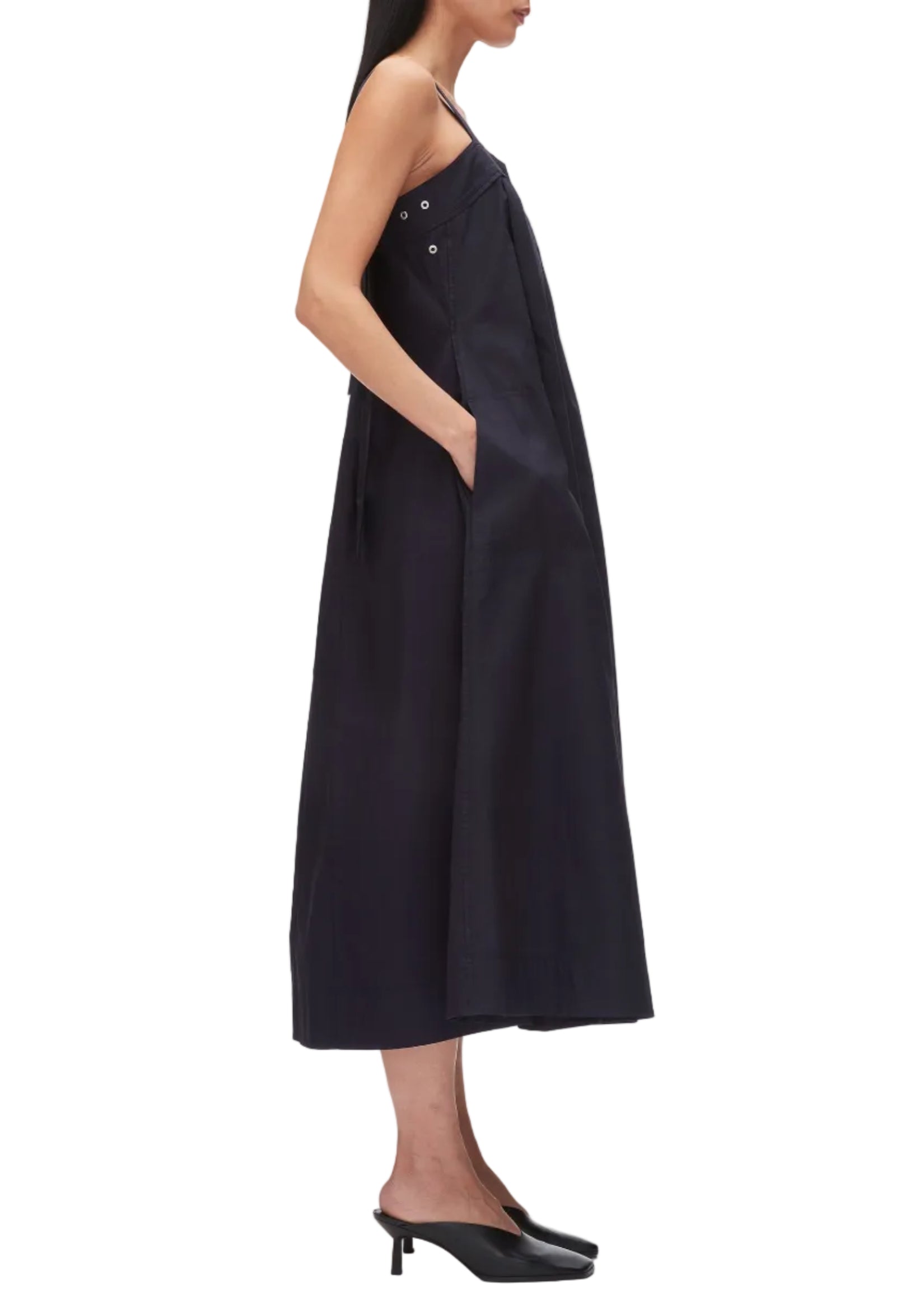 A woman in profile wears the 3.1 Phillip Lim Structured Cotton Poplin Midi Dress with pockets and black heeled shoes, set against a white background.