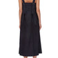 A woman is seen from the back wearing the 3.1 Phillip Lim Structured Cotton Poplin Midi Dress with wide straps, a bow detail, and a square neckline, styled with black heeled shoes.