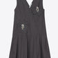 3.1 Phillip Lim Draped Tank Dress with Floral Applique features a sleeveless design in dark gray, a knee-length pleated skirt, and is adorned with two beaded floral appliqués on the chest and hip.