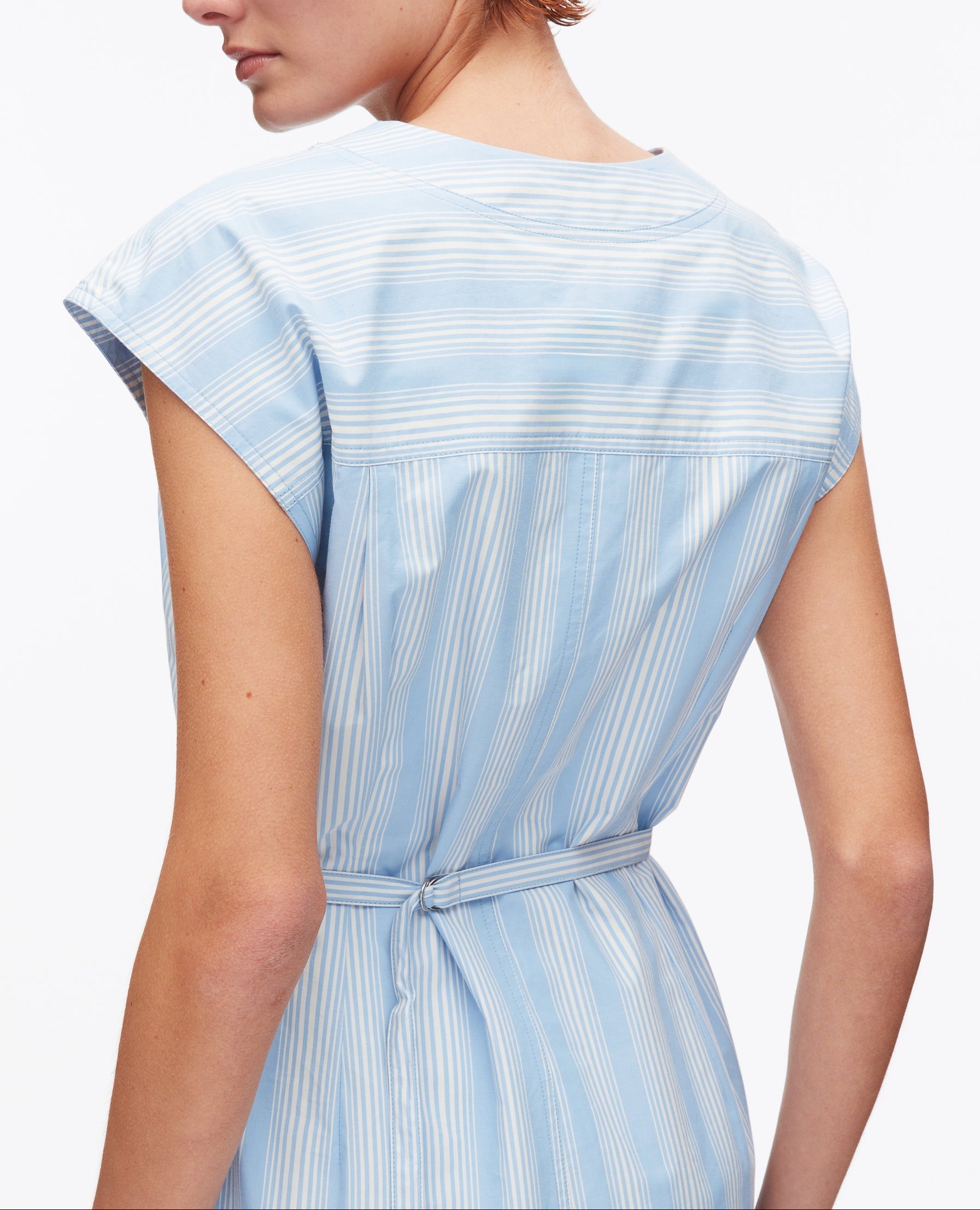 A person is seen from the back wearing the 3.1 Phillip Lim Striped Cap Sleeve Knee-Length Dress with a thin waist belt—an ideal spring and summer look.