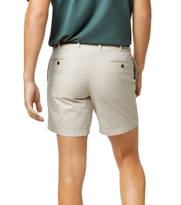 Person wearing Sid Mashburn 7" inseam lightweight cotton twill shorts in beige and a green top, viewed from the waist down.