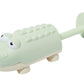 A green plastic fish-shaped Sunnylife Water Squirters with wheels and a handle, isolated on a white background.