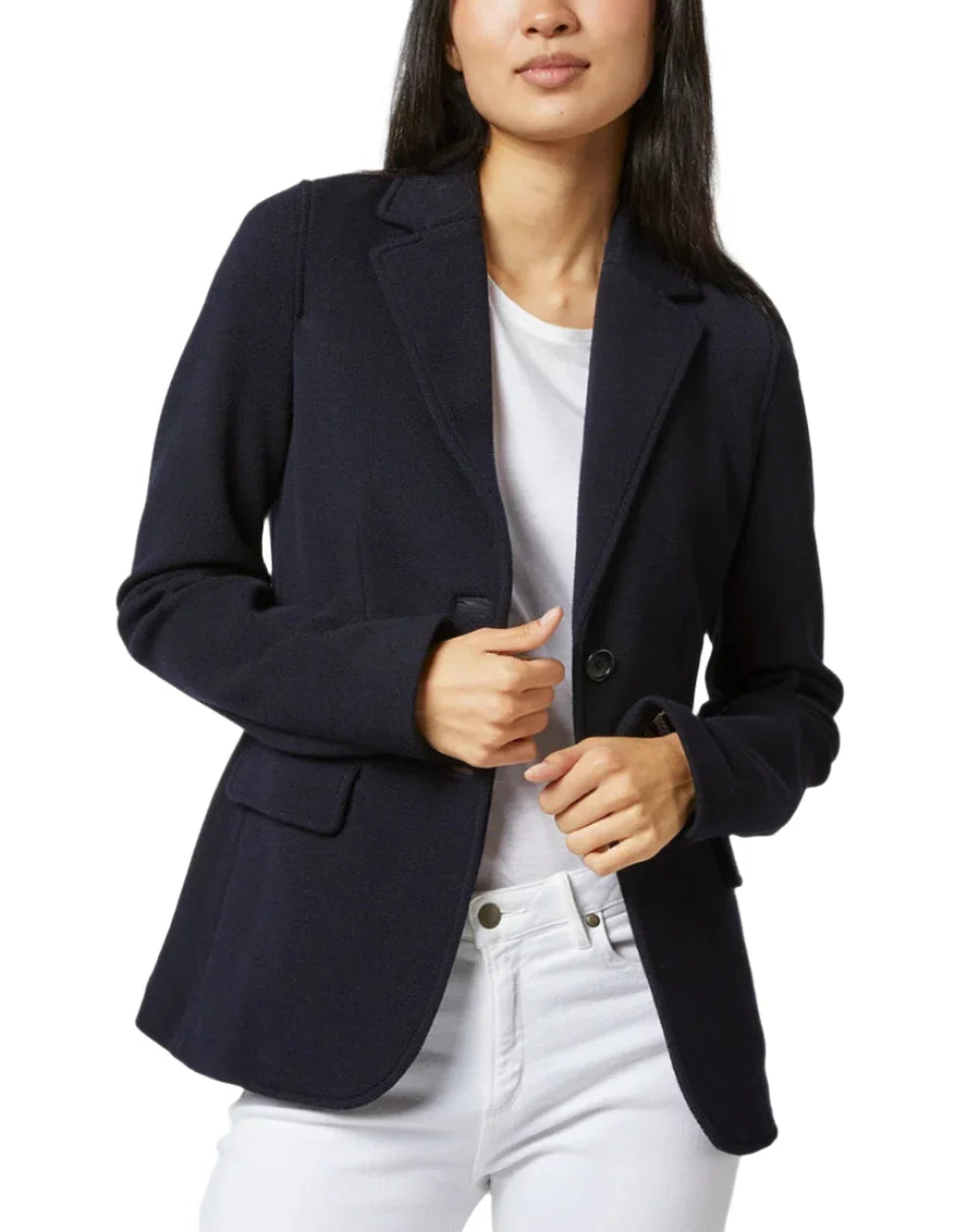 A person wearing the Ann Mashburn Parker Jacket in navy over a white shirt and white pants stands in a relaxed pose against a plain background, epitomizing the perfect travel piece.