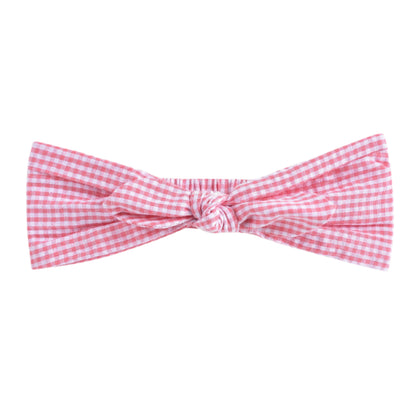 Elevate any outfit with the Baby Cally Headband by Louise Misha, showcasing a pink gingham design and a charming twisted knot, perfect for little girls.