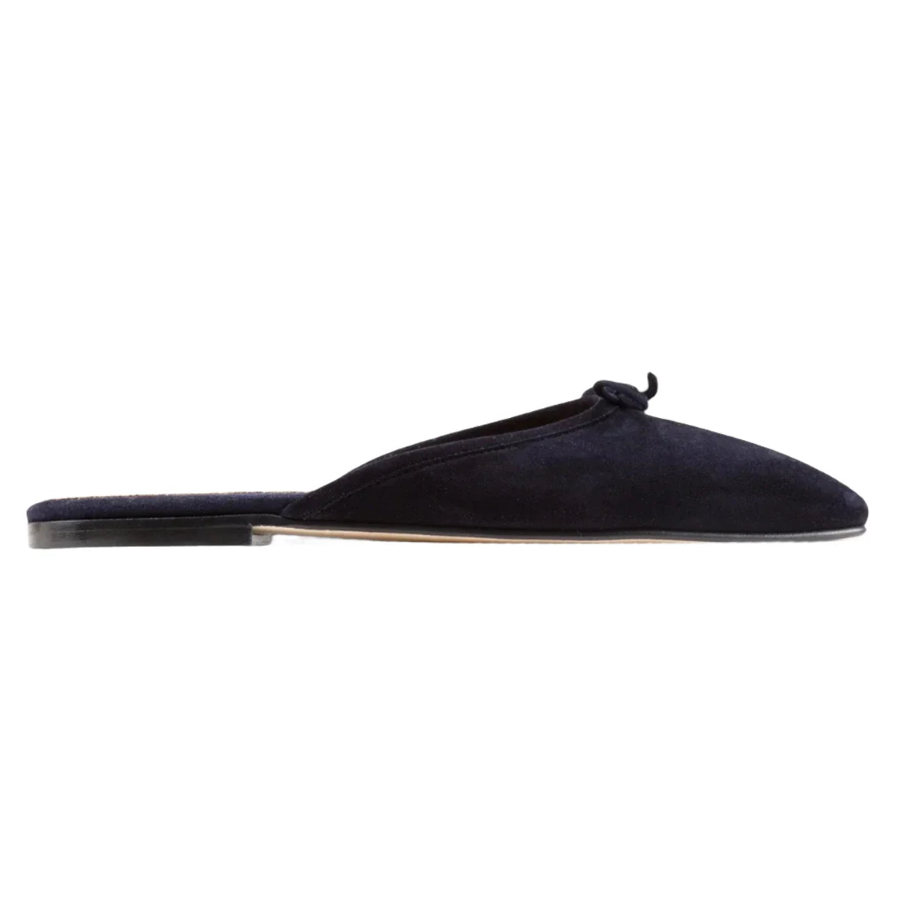 The Ann Mashburn Joy Mule in black calf suede features a flat sole, a small bow on the upper, and a backless design, as shown in the side view.